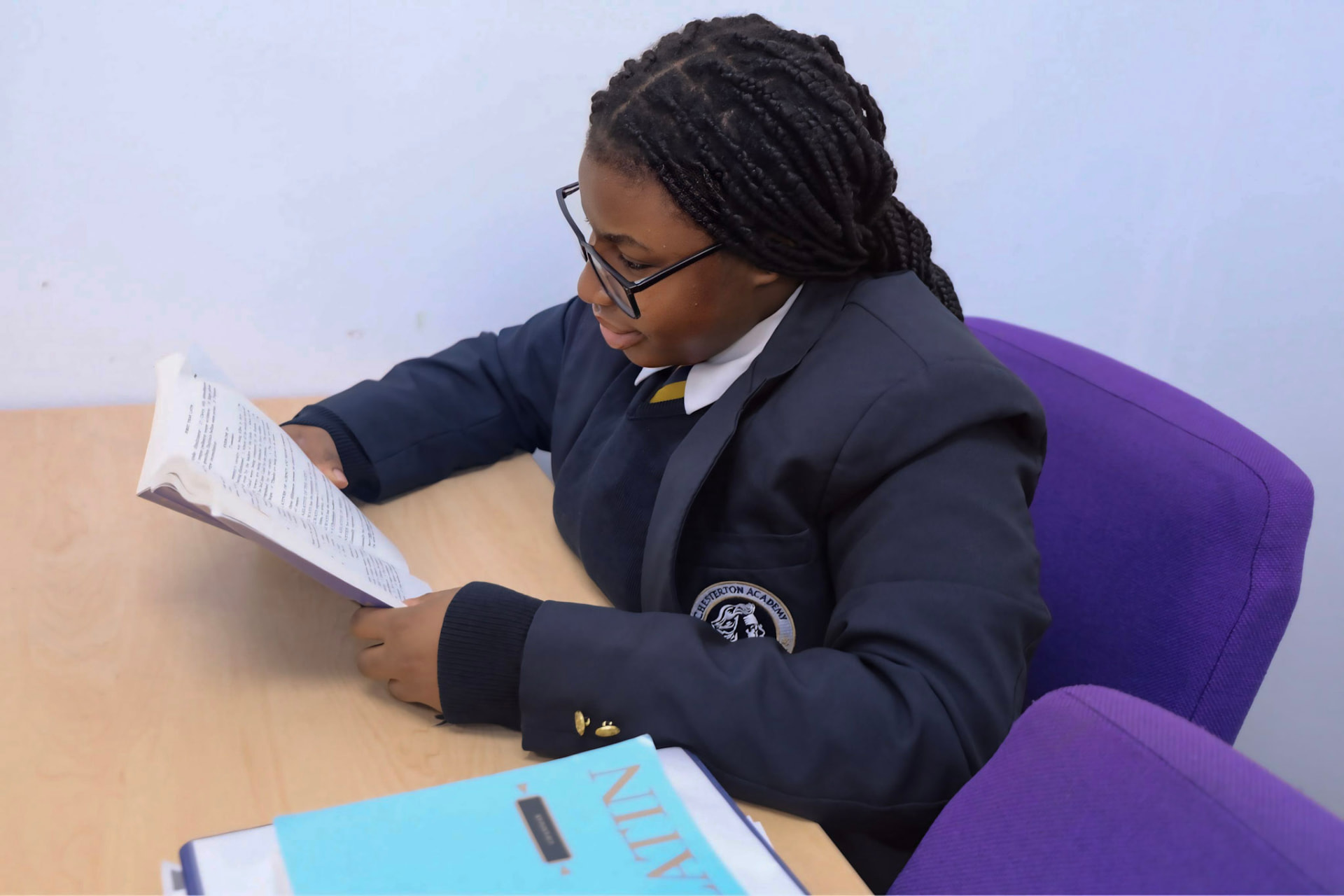 A student reading a Latin text at her desk